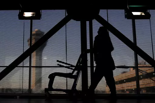 An airline employee transfers a wheelchair to her station at O'Hare International Airport in Chicago, Nov. 23, 2022. The Biden administration will propose Thursday, Feb. 29, 2024, to make it easier for the government to fine airlines for damaging or misplacing wheelchairs by making it an automatic violation of a federal law on accessible air travel. (AP Photo/Nam Y. Huh, File)