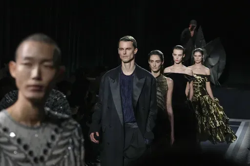 Models wear creations for the men's and women's Lanvin Fall-Winter 2025-2026 collection, presented in Paris, Sunday, Jan. 26, 2025. (AP Photo/Michel Euler)