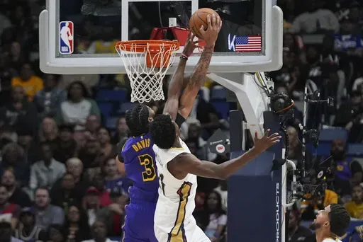 Los Angeles Lakers forward Anthony Davis (3) and New Orleans Pelicans center Yves Missi battle under the basket in the first half of an NBA basketball game in New Orleans, Saturday, Nov. 16, 2024. (AP Photo/Gerald Herbert)