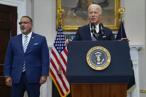 President Joe Biden speaks in the Roosevelt Room of the White House, June 30, 2023, in Washington, as his administration is moving forward on a new student debt relief plan after the Supreme Court struck down his original initiative. Education Secretary Miguel Cardona listens at left. Two conservative groups are asking a federal court to block the Biden administration’s plan to cancel $39 billion in student loans for more than 800,000 borrowers. (AP Photo/Evan Vucci, File)