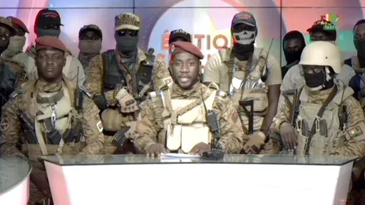 In this image from video broadcast by RTB state television, coup spokesman Capt. Kiswendsida Farouk Azaria Sorgho reads a statement in a studio in Ougadougou, Burkina Faso, on Friday evening, Sept. 30, 2022. Members of Burkina Faso's army seized control of state television late Friday, declaring that the country's coup leader-turned-president, Lt. Col. Paul Henri Sandaogo Damiba, had been overthrown after only nine months in power. The statement announced that Capt. Ibrahim Traore is the new mil