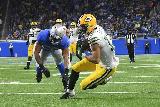 Green Bay Packers wide receiver Allen Lazard (13) catches a 29-yard pass for a touchdown during the first half of an NFL football game against the Detroit Lions, Sunday, Jan. 9, 2022, in Detroit. (AP Photo/Lon Horwedel)