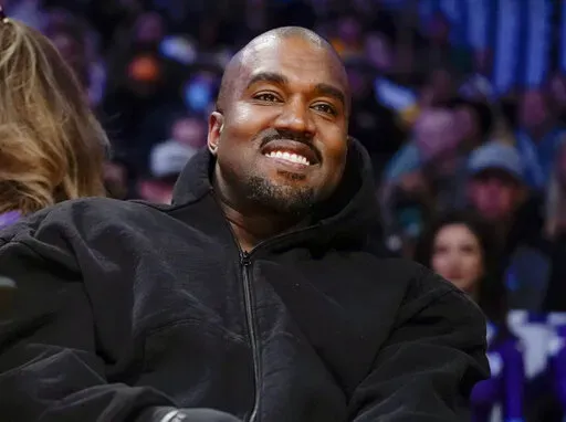 Kanye West watches the first half of an NBA basketball game between the Washington Wizards and the Los Angeles Lakers in Los Angeles, on March 11, 2022 Adidas has ended its partnership with the rapper formerly known as Kanye West over his offensive and antisemitic remarks. (AP Photo/Ashley Landis, File)