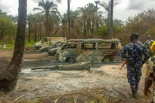 People gather Saturday April 23, 2022 at the site of an explosion that took place the day before at an illegal oil refinery in Ohaji-Egbema local government area in Imo state, southeast Nigeria. At least 100 people are feared to have died in the explosion, authorities told The Associated Press, as the search for bodies at the site and for two people suspected of being involved in the incident intensified. (AP Photo)