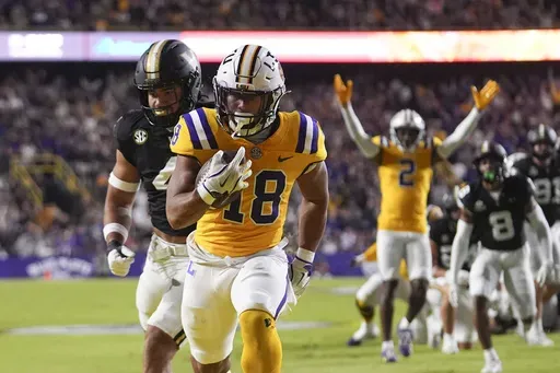 LSU running back Josh Williams (18) carries for a touchdown in the first half of an NCAA college football game against Vanderbilt in Baton Rouge, La., Saturday, Nov. 23, 2024. (AP Photo/Gerald Herbert)