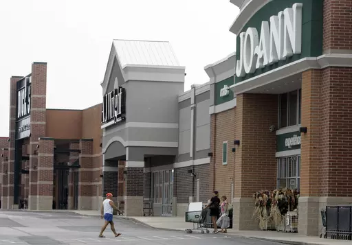 People walk into and out of a Joann store, Sept. 6, 2007, in Garfield Heights, Ohio. The fabric and crafts retailer has filed for Chapter 11 bankruptcy protection, as consumers continue to cut back on discretionary spending. In a Monday, March 18, 2024 release, the Hudson, Ohio-based company said that it expected to emerge from bankruptcy as early as the end of next month. (AP Photo/Tony Dejak, file)