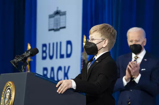 Joshua Davis, 12, introduces President Joe Biden to speak about prescription drug costs at the Daniel Technology Center of Germanna Community College – Culpeper Campus, Thursday, Feb. 10, 2022, in Culpeper, Va. (AP Photo/Alex Brandon)