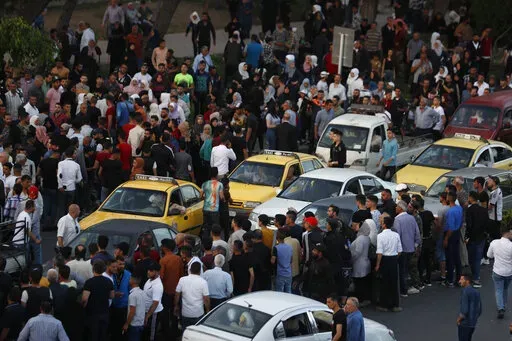 Dozens of Syrians wait at the President's Bridge in Damascus for relatives they hope would be among those released from prison May 3, 2022, on the second day of the Muslim Fitr holiday. A newly released video taken in 2013 showed blindfolded men who were thrown into a large pit and shot dead by Syrian agents, who then set the bodies on fire. The video stirs new fears over the fate of tens of thousands who went missing during Syria's long-running conflict and serves as a grim reminder of the war'