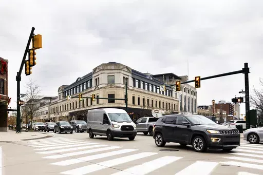 This undated photo provided by the University of Michigan College of Engineering shows vehicles as they drive through the Old Woodward Avenue and East Maple signalized intersection, which was retimed using the Optimized Signal as a Service (OSaaS), in Birmingham, Mich. Smarter vehicles could mean some of the most dramatic changes for the traditional traffic signal since the yellow light was added more than a century ago. (Jeremy Little/University of Michigan College of Engineering via AP)