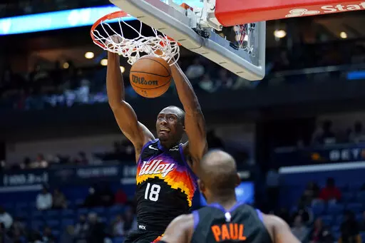 Phoenix Suns center Bimack Biyombo (18) clam dunks in the second half of an NBA basketball game against the New Orleans Pelicans in New Orleans, Tuesday, Jan. 4, 2022. The Suns won 123-110. (AP Photo/Gerald Herbert)