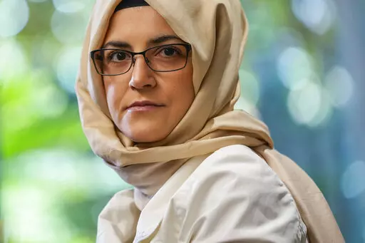 Hatice Cengiz, the fiancee of murdered Saudi journalist Jamal Kashoggi, poses for a photograph during an interview with The Associated Press in Istanbul, Turkey, Thursday, July 14, 2022. Cengiz described Joe Biden's decision to visit Saudi Arabia as "heartbreaking," accusing the U.S. president on Thursday of backing down from his pledge of prioritizing human rights. (AP Photo/Francisco Seco)
