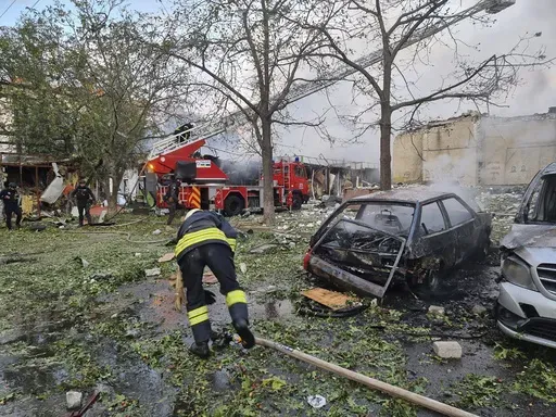 In this photo provided by the Ukrainian Emergency Service, emergency services personnel work to extinguish a fire following a Russian attack in Cherkasy, Ukraine, Thursday, Sept. 21, 2023. (Ukrainian Emergency Service via AP)