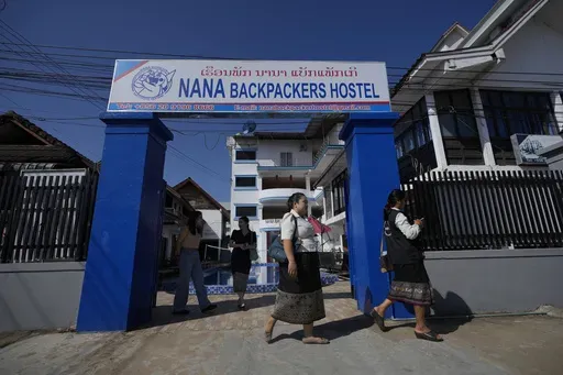 Health officials come out of Nana Backpackers hostel after checking documents in Vang Vieng, Laos, Friday, Nov. 22, 2024. (AP Photo/Anupam Nath)