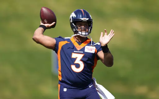 Denver Broncos quarterback Russell Wilson takes part in drills at the NFL football team's voluntary minicamp Wednesday, April 27, 2022, at the team's headquarters in Englewood, Colo. (AP Photo/David Zalubowski)