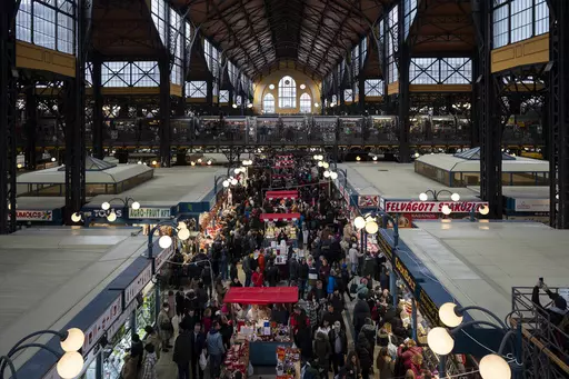 Customers purchase food in Budapest's Grand Market Hall on Saturday, April 8, 2023. Food prices have risen dramatically across Europe in recent months, but Hungary is facing the biggest spike. That's hitting consumers hard, forcing them to change what kind of food they buy and how much of it they can afford. Businesses also are rethinking what they sell as food prices in Hungary surged 45% over the year. In the European Union, those costs jumped 19.6%. (AP Photo/Denes Erdos)