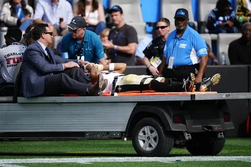 New Orleans Saints wide receiver Chris Olave is taken off the field after getting hurt during the first half of an NFL football game against the Carolina Panthers Sunday, Nov. 3, 2024, in Charlotte, N.C. (AP Photo/Jacob Kupferman)