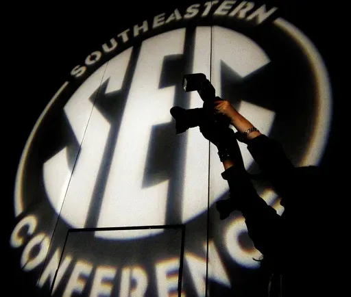 A photographer takes a photo at the Southeastern Conference NCAA college football media days, in Hoover, Ala., July 15, 2014. (AP Photo/Butch Dill, File)