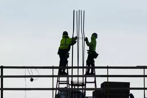 Construction workers work on a building in Philadelphia, Wednesday, Dec. 21, 2022. America’s employers added a solid 223,000 jobs in December, evidence that the economy remains healthy yet also a sign that the Federal Reserve may still have to raise interest rates aggressively to slow growth and cool inflation. (AP Photo/Matt Rourke, File)