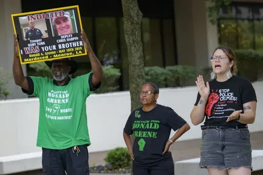 From left, Lumumba Lutalo, Angela "Mama Ghost" Green and Antonia Mar, of New Orleans for Community Oversight of Police, take part in a rally for justice for Ronald Greene at the Eastern District of Louisiana Courthouse in New Orleans, on May 10, 2024. (AP Photo/Matthew Hinton, File)