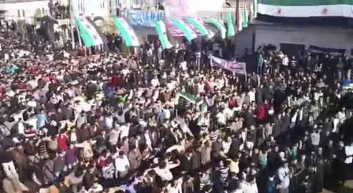 In this image from amateur video made available by the Ugarit News group and shot on Friday, Dec. 30, 2011, protesters gather at an anti-Syrian president Bashar Assad rally in Hama, Syria. (AP Photo/Ugarit News Group via APTN, File)