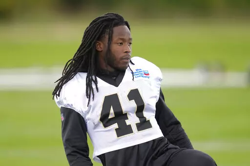 New Orleans Saints running back Alvin Kamara looks on during an NFL practice session at the London Irish rugby team training ground in Sunbury-on-Thames near London, Wednesday, Sept. 28, 2022 ahead of the NFL game against Minnesota Vikings at the Tottenham Hotspur stadium on Sunday. (AP Photo/Kirsty Wigglesworth)