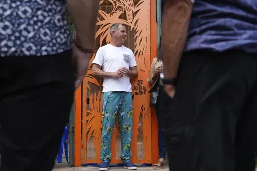 South African sculptor and painter James Delaney speaks to the residents during his official opening his public art installation, at the Killarney Park in Johannesburg, South Africa, Tuesday Feb. 18, 2025. (AP Photo/Alfonso Nqunjana)