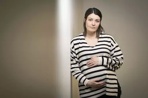 Jillaine St.Michel stands for a portrait in Boise, Idaho on Saturday, Dec. 2, 2023. A year earlier, she learned that her previous 20-week fetus had multiple genetic and developmental problems and probably wouldn’t survive. She lives in Idaho, which has a ban on abortions, so St.Michel and her husband called about 15 out-of-state clinics, finally getting on a three-week waiting list in Denver and a two-week waiting list in Seattle. Pregnant again, she is due to give birth to a boy in January. (