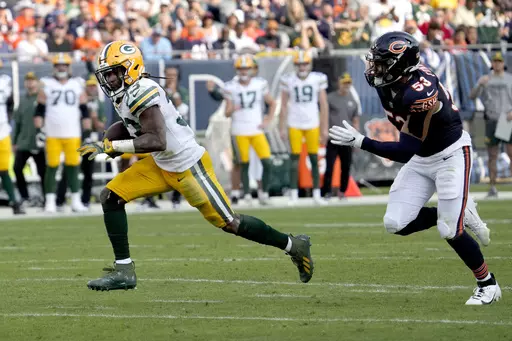Green Bay Packers running back Aaron Jones heads for the end zone for a touchdown as Chicago Bears linebacker T.J. Edwards pursues during the second half of an NFL football game Sunday, Sept. 10, 2023, in Chicago. (AP Photo/Nam Y. Huh)