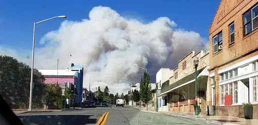 A plum of smoke covers the sky as the the Mill Fire approaches in Weed, Calif. Friday, Sept. 2, 2022. (Hung T. Vu/The Record Searchlight via AP)