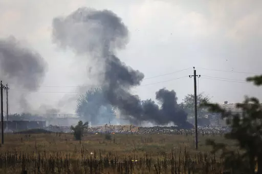 Smoke rises over the site of explosion at an ammunition storage of Russian army near the village of Mayskoye, Crimea, Tuesday, Aug. 16, 2022. Explosions and fires ripped through an ammunition depot in Russian-occupied Crimea on Tuesday in the second suspected Ukrainian attack on the peninsula in just over a week, forcing the evacuation of more than 3,000 people. (AP Photo)