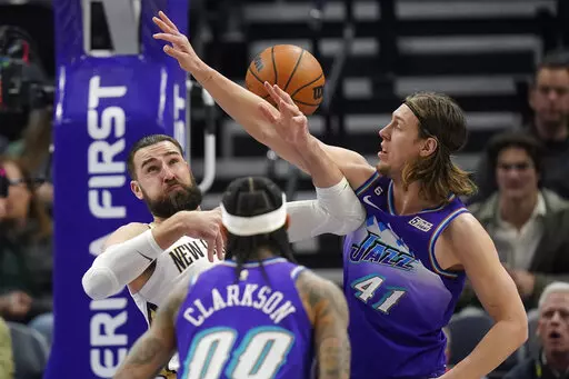 Utah Jazz forward Kelly Olynyk (41) defends against New Orleans Pelicans center Jonas Valanciunas, rear, during the first half of an NBA basketball game Thursday, Dec. 15, 2022, in Salt Lake City. (AP Photo/Rick Bowmer)