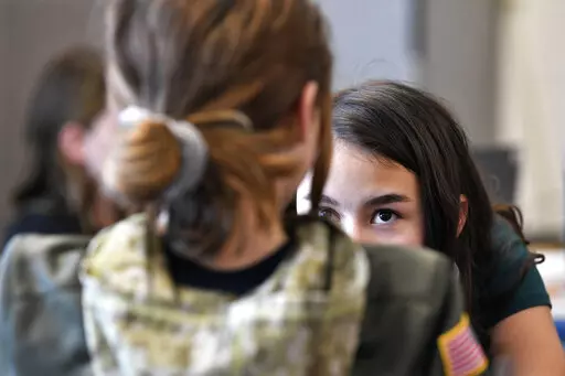 Bella Whitice talks with classmate Katherine McCormick as they try and outwit the "robot" that was creating writing assignments in Donnie Piercey's class at Stonewall Elementary in Lexington, Ky., Monday, Feb. 6, 2023.The robot was the new artificial intelligence tool ChatGPT which can generate everything from essays and haikus to term papers in a matter of seconds. (AP Photo/Timothy D. Easley)