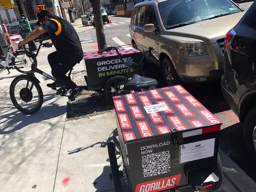 A worker sets to make a delivery on a bicycle in front of Gorillas mini-warehouse in the Williamsburg section of the Brooklyn borough of New York on Monday, April 12, 2022.   Gorillas is one of several companies that venture capitalists have poured billions into in the latest pandemic delivery craze.They typically deliver from mini-warehouses in residential and commercial neighborhoods. (AP Photo/Tali Arbel)