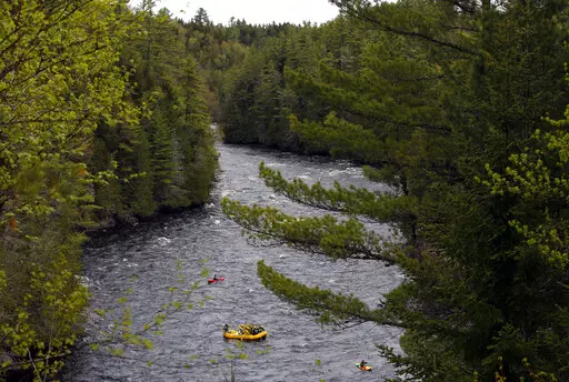 Whitewater rafters paddle on the Kennebec River in The Forks, Maine, on May 28, 2019. On the Kennebec River, conservation groups and state environmental agencies are pushing for the removal of four hydropower dams that block endangered Atlantic salmon from reaching habitat. The dams generate about 5% of the state’s renewable energy. (AP Photo/Robert F. Bukaty, File)