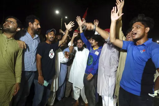 Supporters of an opposition party celebrate the success of a no-confidence vote against Prime Minister Imran Khan, in Karachi, Pakistan, Sunday, April 10, 2022. Pakistan's political opposition toppled Prime Minister Khan in a no-confidence vote in Parliament early Sunday after several political allies and a key party in his ruling coalition deserted him. (AP Photo/Fareed Khan)