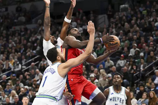 New Orleans Pelicans forward Zion Williamson, right, drives to the basket past Minnesota Timberwolves forward Kyle Anderson (1) and center Naz Reid during the first half of an NBA basketball game Wednesday, Jan. 3, 2024, in Minneapolis. (AP Photo/Craig Lassig)