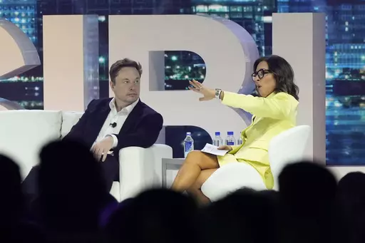 Twitter CEO Elon Musk, center, speaks with Linda Yaccarino, chairman of global advertising and partnerships for NBC, at the POSSIBLE marketing conference, Tuesday, April 18, 2023, in Miami Beach, Fla. Musk announced Friday, May 12, 2023, that he's hiring Yaccarino to be the new CEO of San Francisco-based Twitter, which is now called X Corp. (AP Photo/Rebecca Blackwell, File)