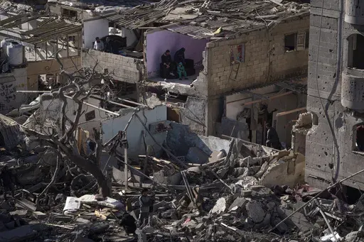 Palestinians look at the destruction after an Israeli strike on residential buildings and a mosque in Rafah, Gaza Strip, Feb. 22, 2024. Israel and Hamas appear to be seriously negotiating an end to the war in Gaza and the return of Israeli hostages. A leaked truce proposal hints at concessions by both sides following months of stalemated talks. (AP Photo/Fatima Shbair, File)