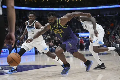 New Orleans Pelicans forward Zion Williamson (1) drives to the basket ahead of Minnesota Timberwolves guard Anthony Edwards (5) and forward Julius Randle (30) in the second half of an NBA basketball game in New Orleans, Tuesday, Jan. 7, 2025. The Timberwolves won 104-97 (AP Photo/Gerald Herbert)