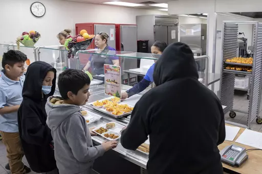Students select their meal during lunch break in the cafeteria at V. H. Lassen Academy of Science and Nutrition in Phoenix, Tuesday, Jan. 31, 2023. (AP Photo/Alberto Mariani)