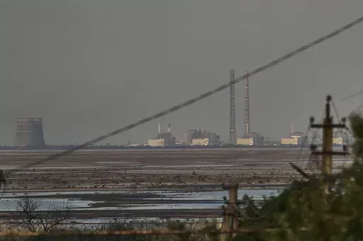 The Zaporizhzhia nuclear power plant, Europe's largest, is seen in the background of the shallow Kakhovka Reservoir after the dam collapse, in Energodar, Russian-occupied Ukraine, Tuesday, June 27, 2023. Officials at the Russian-controlled Zaporizhzhia Nuclear Power Plant said that the site was attacked Sunday April 7, 2024, by Ukrainian military drones, including a strike on the dome of the plant’s sixth power unit. (AP Photo/Libkos, File)