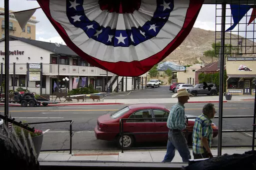 People walk along the main drag in the county seat of Nye County on July 18, 2022, in Tonopah, Nev. The American Civil Liberties Union of Nevada asked the state's secretary of state Wednesday, Nov. 2 to formally investigate allegations of partisan improprieties in a hand-count of advance election ballots that's currently on hold in rural Nye County after a state Supreme Court ruling raised questions about the legality of the process last week. (AP Photo/John Locher, File)
