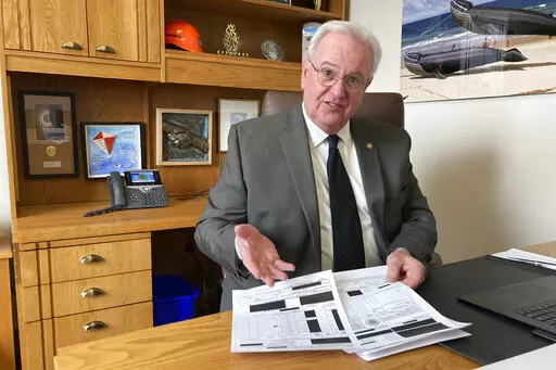 Oregon state Rep. David Gomberg shows a reporter heavily redacted documents he received from the Oregon National Primate Research Center in his office in the Oregon State Capitol in Salem, Ore., on Tuesday, Jan. 24, 2023. Rep. Gomberg is behind a bill in the Oregon Legislature calling for greater oversight of the center after two monkeys died when they were put into a scalding cage-washing machine and other safety violations. (AP Photo/Andrew Selsky)