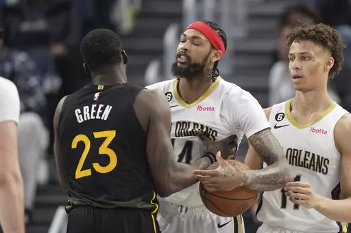 Golden State Warriors forward Draymond Green (23) and New Orleans Pelicans forward Brandon Ingram, center, confront each other as guard Dyson Daniels (11) looks on during the second quarter of an NBA basketball game Tuesday, March 28, 2023, in San Francisco. (AP Photo/Darren Yamashita)