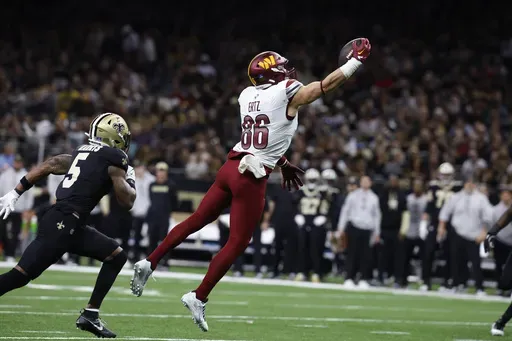 Washington Commanders tight end Zach Ertz (86) makes a catch in the first half of an NFL football game against the New Orleans Saints in New Orleans, Sunday, Dec. 15, 2024. (AP Photo/Butch Dill)