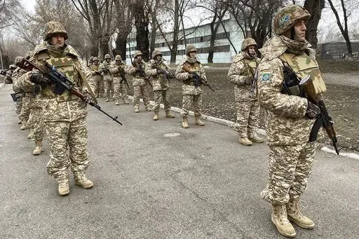 In this photo released by the Russian Defense Ministry Press Service, Collective Security Treaty Organization peacekeepers prepare to guard an area in Almaty, Kazakhstan, Tuesday, Jan. 11, 2022. The president of Kazakhstan has announced that a Russia-led security alliance will start pulling out its troops from the Central Asian country in two days after completing its mission. The mostly Russian troops were deployed to Kazakhstan last week by the Collective Security Treaty Organization, an allia