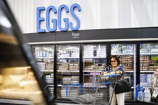 A woman buys eggs at a Walmart Superstore in Secaucus, New Jersey, on July 11, 2024. (AP Photo/Eduardo Munoz Alvarez)