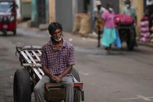 A daily wage laborer waits for work at a wholesale market in Colombo, Sri Lanka, Sunday, June 26, 2022. Sri Lankans have endured months of shortages of food, fuel and other necessities due to the country's dwindling foreign exchange reserves and mounting debt, worsened by the pandemic and other longer term troubles. Some 1.6 billion people in 94 countries face at least one dimension of the crisis in food, energy and financial systems, according to a report last month by the Global Crisis Respons