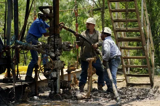 Oil well workers prepare to plug an orphaned well on the Rooke family ranch, May 18, 2021, near Refugio, Texas. An environmental group sued the Department of Interior in federal court Thursday, July 11, 2024, for allegedly failing to account for the harms caused by delays in properly shutting down offshore oil and gas infrastructure. (AP Photo/Eric Gay, File)