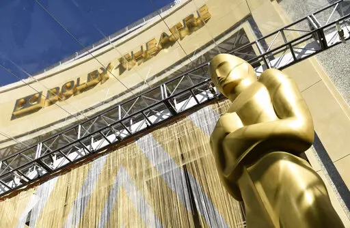 An Oscar statue is pictured underneath the entrance to the Dolby Theatre on Feb. 24, 2016, in Los Angeles. The Oscars will be held on Sunday, March 27 at the Dolby Theatre in Los Angeles. The ceremony is set to begin at 8 p.m. ET and will be broadcast live on ABC. (Photo by Chris Pizzello/Invision/AP, File)